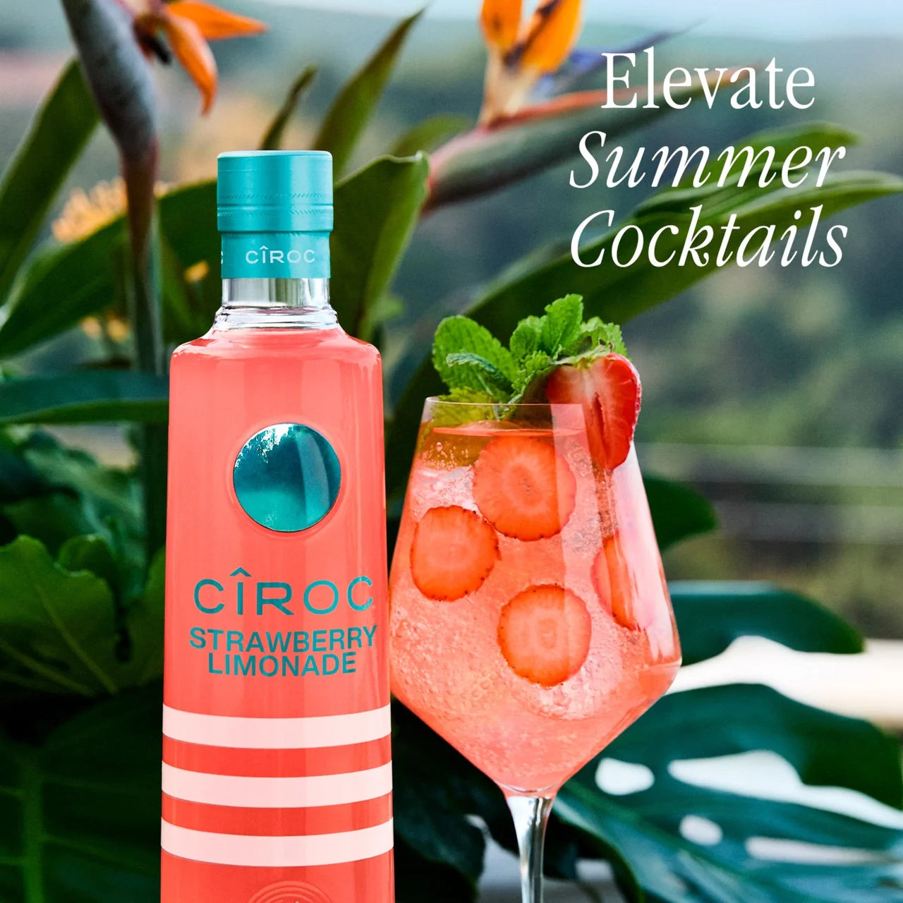 Ciroc Strawberry Lemonade bottle with a strawberry lemonade cocktail against a tropical background