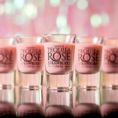 Tequila Rose Strawberry Cream shots with a blurred pink background
