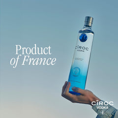 Côroc vodka bottle held by a hand with 'Product of France' text on a blue background