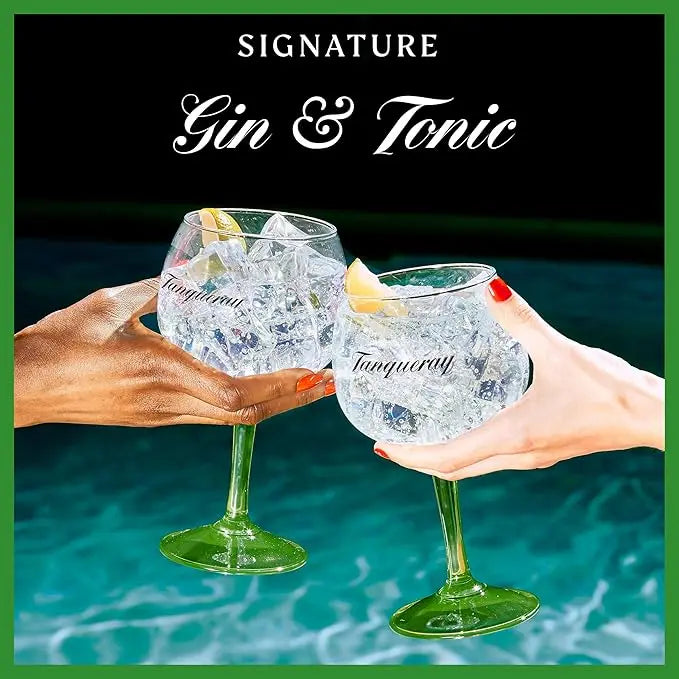 Two hands holding Tanqueray gin and tonic glasses with ice and lemon slices against a pool background.