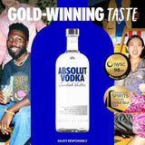 Absolut Vodka bottle with gold-winning text and people in the background