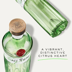 Green bottle with gold cap and white label on a light gray background