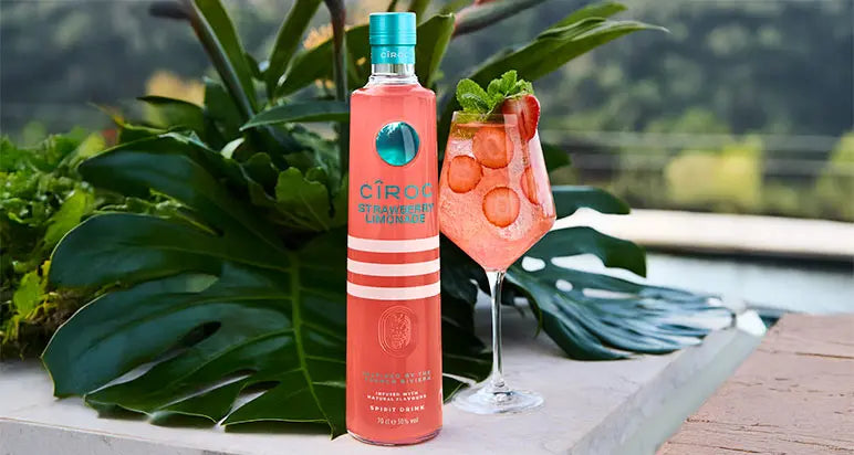 Ciroc Vodka bottle with a cocktail on a scenic outdoor setting