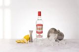Glen's Vodka bottle with ice, lemons, and a cocktail shaker on a white background