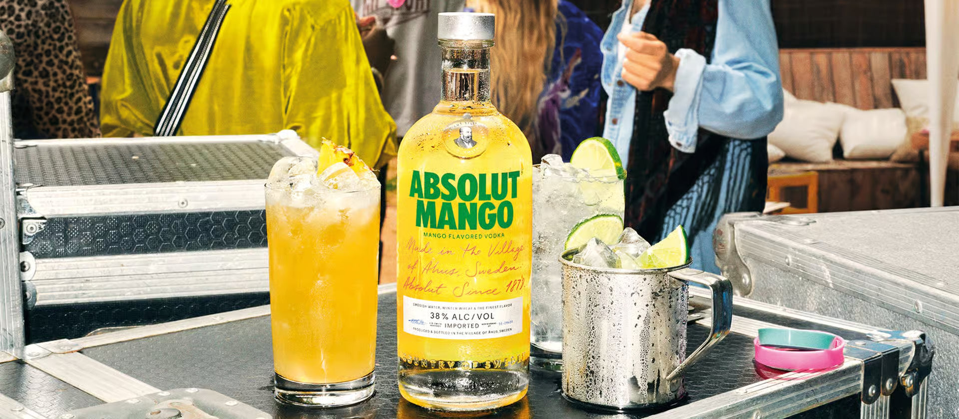 Absolut Mango bottle with cocktails on a bar counter