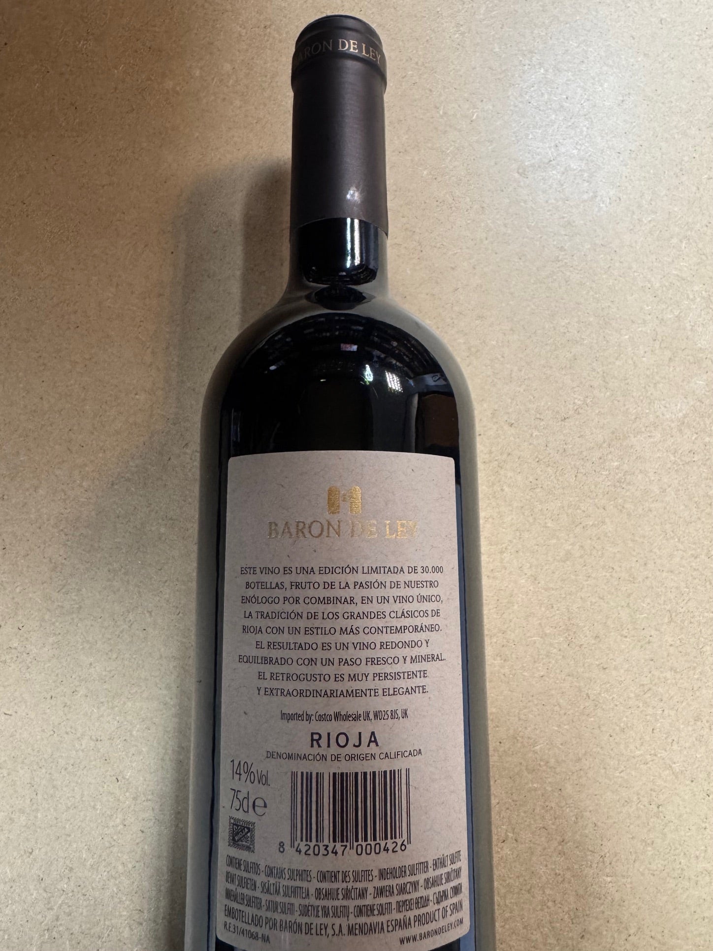 Wine bottle with label on a beige background